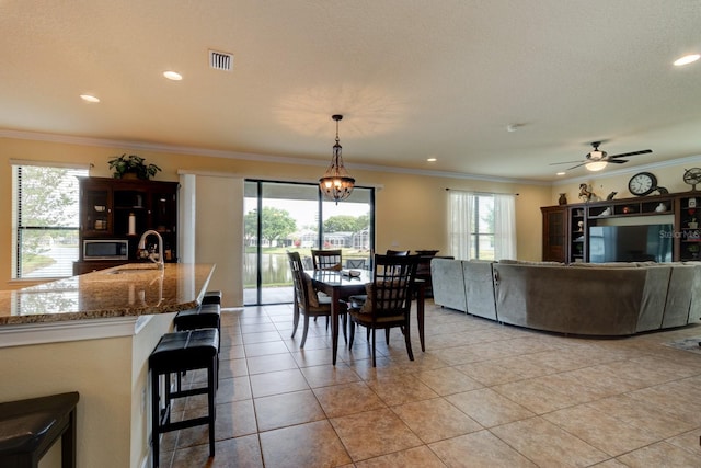 1703 Frogs Leap Ct, Port Orange, FL 32128 - dining room with light tile patterned floors, recessed lighting, a ceiling fan, and ornamental molding