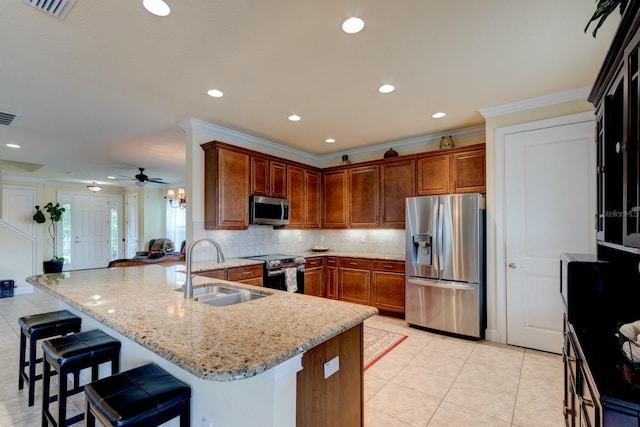 1703 Frogs Leap Ct, Port Orange, FL 32128 - kitchen featuring light stone counters, decorative backsplash, a sink, appliances with stainless steel finishes, and a peninsula