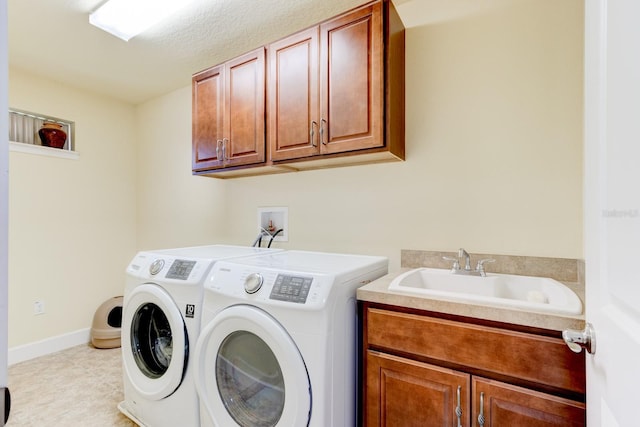 1703 Frogs Leap Ct, Port Orange, FL 32128 - laundry area featuring independent washer and dryer, baseboards, cabinet space, and a sink
