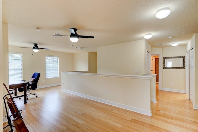 1703 Frogs Leap Ct, Port Orange, FL 32128 - office area with light wood finished floors, a ceiling fan, a textured ceiling, and baseboards