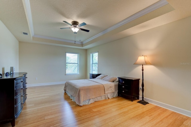 1703 Frogs Leap Ct, Port Orange, FL 32128 - bedroom featuring crown molding, light wood finished floors, baseboards, and a tray ceiling