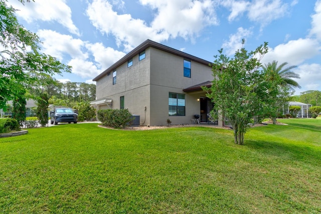 1703 Frogs Leap Ct, Port Orange, FL 32128 - back of house featuring stucco siding and a lawn