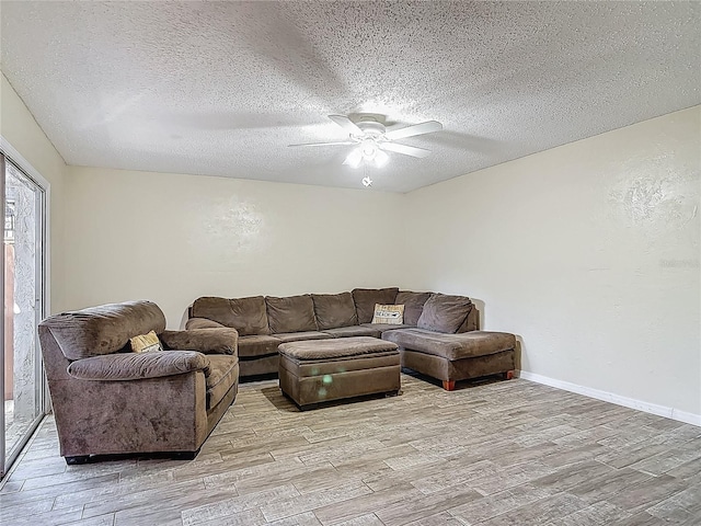 95 Moonstone Ct, Port Orange, FL 32129 - living area featuring light wood-style floors, ceiling fan, a textured ceiling, and baseboards