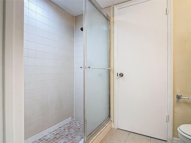 95 Moonstone Ct, Port Orange, FL 32129 - bathroom featuring a shower stall, tile patterned flooring, and toilet