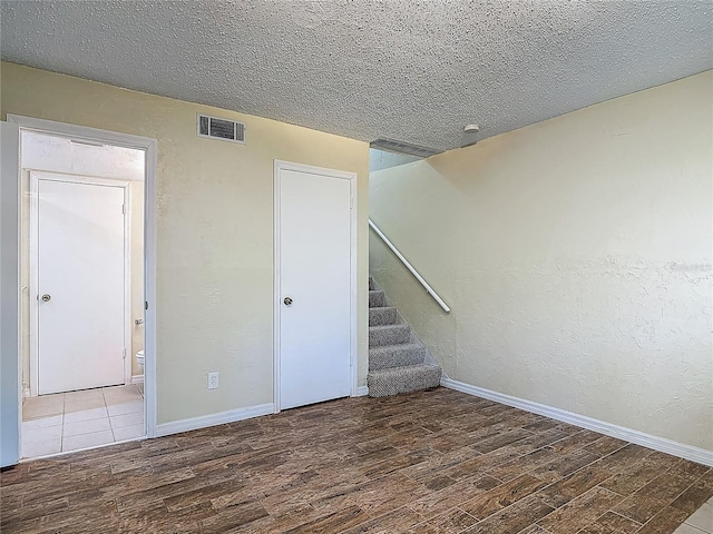 95 Moonstone Ct, Port Orange, FL 32129 - unfurnished room with wood finished floors, baseboards, and a textured ceiling