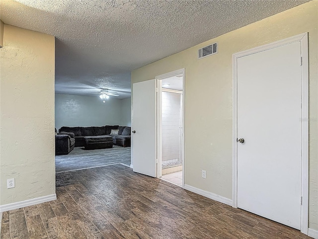 95 Moonstone Ct, Port Orange, FL 32129 - unfurnished living room featuring wood finished floors, a textured ceiling, a textured wall, ceiling fan, and baseboards