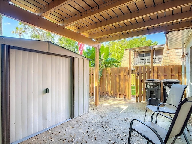 95 Moonstone Ct, Port Orange, FL 32129 - view of patio / terrace featuring a shed, fence, and an outbuilding
