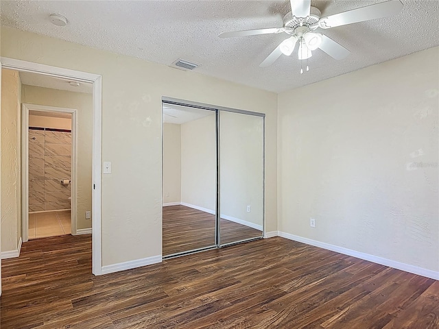 95 Moonstone Ct, Port Orange, FL 32129 - unfurnished bedroom featuring wood finished floors, a textured ceiling, a closet, a ceiling fan, and baseboards
