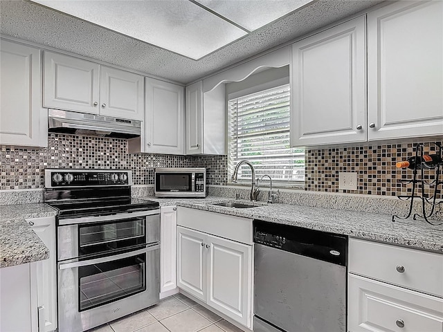 95 Moonstone Ct, Port Orange, FL 32129 - kitchen featuring appliances with stainless steel finishes, a sink, under cabinet range hood, and white cabinets