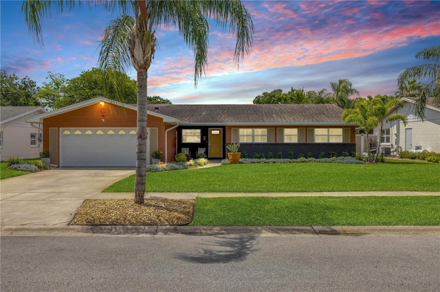 2548 E Compton St, Orlando, FL 32806 - view of front of house with an attached garage, concrete driveway, and a front yard