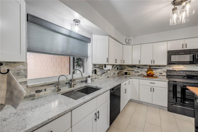 2548 E Compton St, Orlando, FL 32806 - kitchen with backsplash, light stone countertops, a sink, black appliances, and white cabinetry