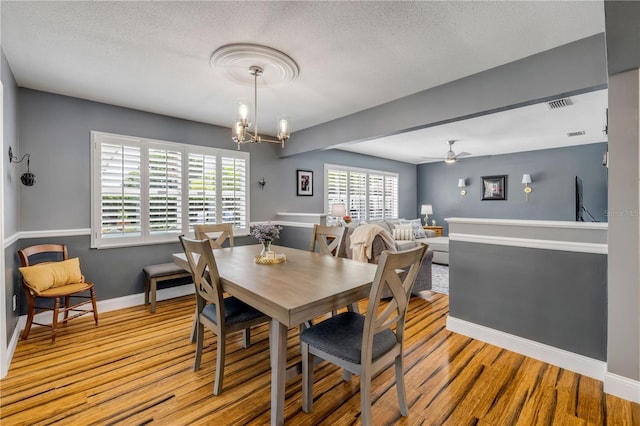2548 E Compton St, Orlando, FL 32806 - dining area with a textured ceiling, baseboards, visible vents, and wood finished floors