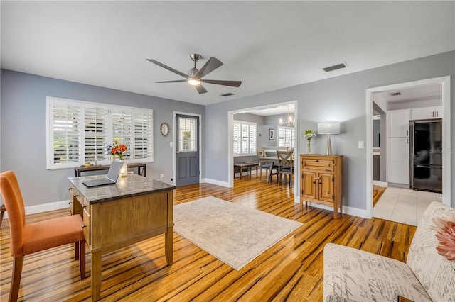 2548 E Compton St, Orlando, FL 32806 - home office with baseboards, visible vents, ceiling fan with notable chandelier, and light wood-type flooring