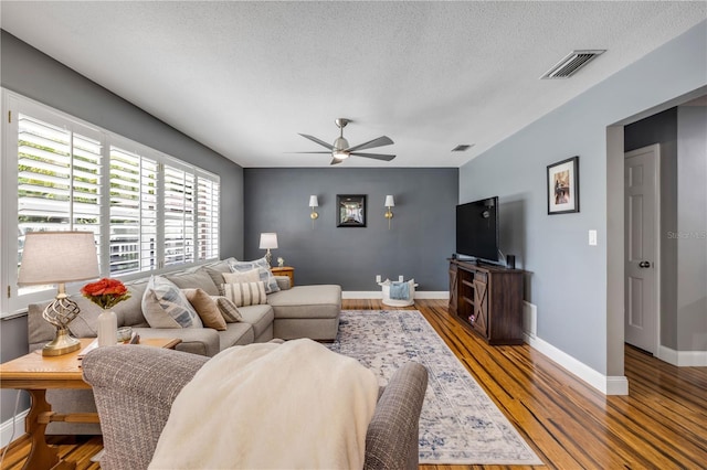 2548 E Compton St, Orlando, FL 32806 - living room with a ceiling fan, baseboards, visible vents, and wood finished floors