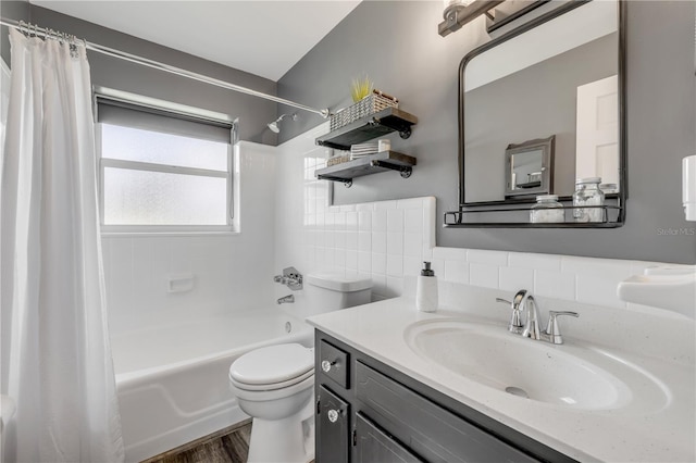 2548 E Compton St, Orlando, FL 32806 - full bath featuring vanity, shower / bathtub combination with curtain, wood finished floors, and toilet