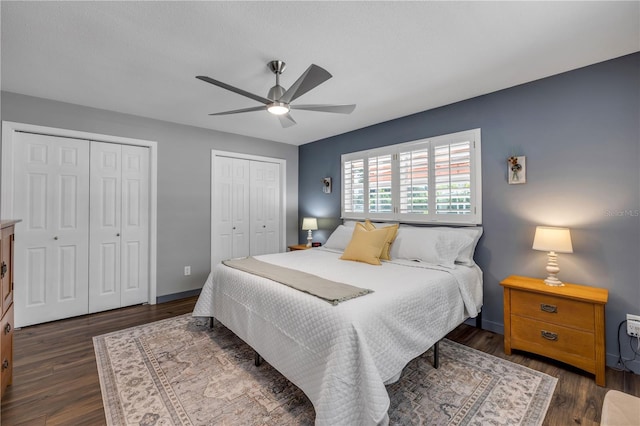 2548 E Compton St, Orlando, FL 32806 - bedroom featuring baseboards, dark wood finished floors, ceiling fan, and two closets