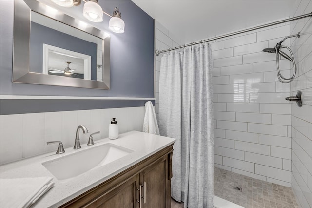 2548 E Compton St, Orlando, FL 32806 - bathroom featuring wainscoting, ceiling fan, a shower stall, and vanity