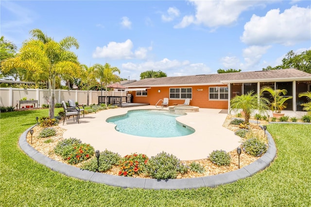 2548 E Compton St, Orlando, FL 32806 - view of pool with fence, a fenced in pool, an in ground hot tub, a patio area, and a lawn