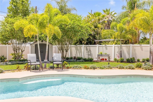 2548 E Compton St, Orlando, FL 32806 - view of swimming pool featuring a fenced in pool, an outdoor structure, a fenced backyard, and a storage unit
