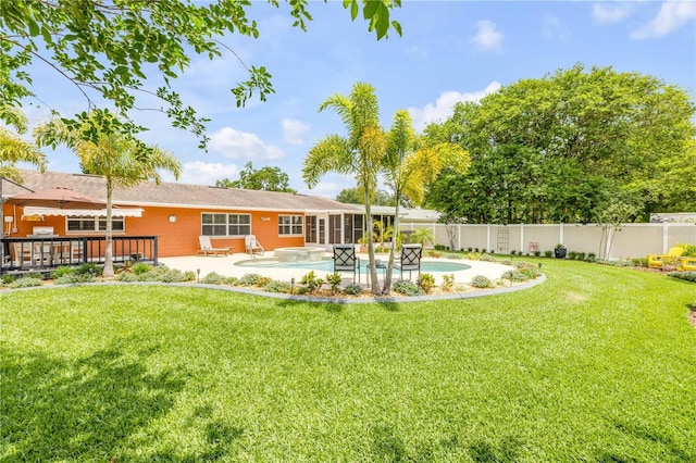 2548 E Compton St, Orlando, FL 32806 - back of house with a sunroom, a fenced in pool, a fenced backyard, a patio area, and a yard
