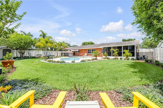 2548 E Compton St, Orlando, FL 32806 - view of yard with a sunroom, a fenced backyard, a shed, and a fenced in pool