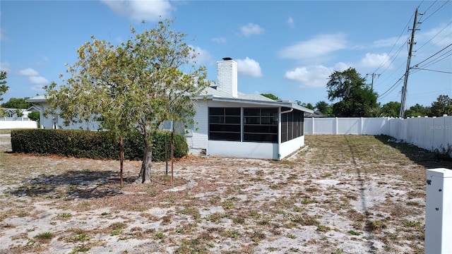 1077 Willow Wood Dr, Port Orange, FL 32129 - fenced backyard with a sunroom