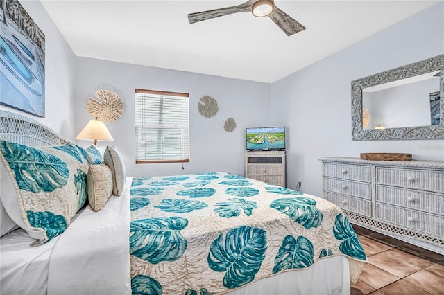 tiled bedroom featuring ceiling fan