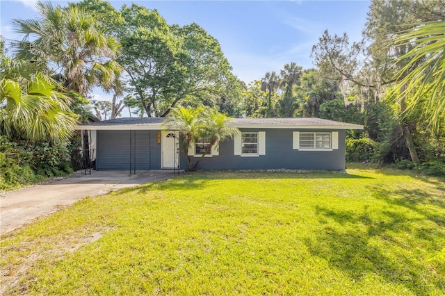 431 Palmetto St, Edgewater, FL 32132 - view of front of property featuring concrete driveway, a front lawn, and a carport