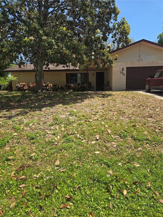 ranch-style house featuring an attached garage and driveway