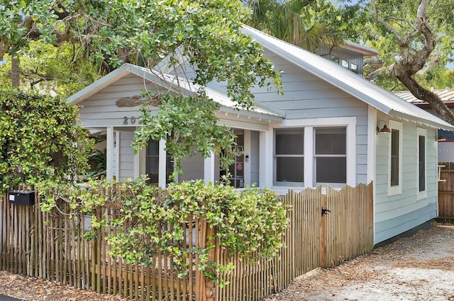 view of side of home featuring fence