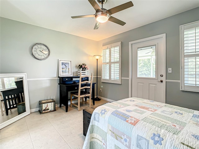 bedroom featuring light tile patterned flooring, baseboards, and a ceiling fan