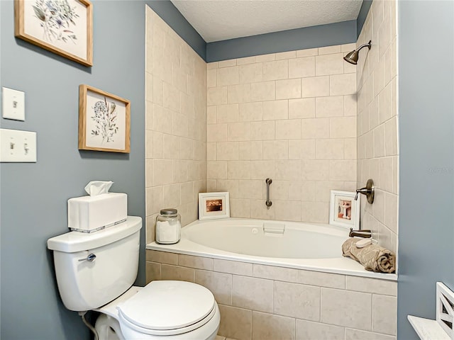 full bathroom featuring tiled shower / bath, toilet, and a textured ceiling