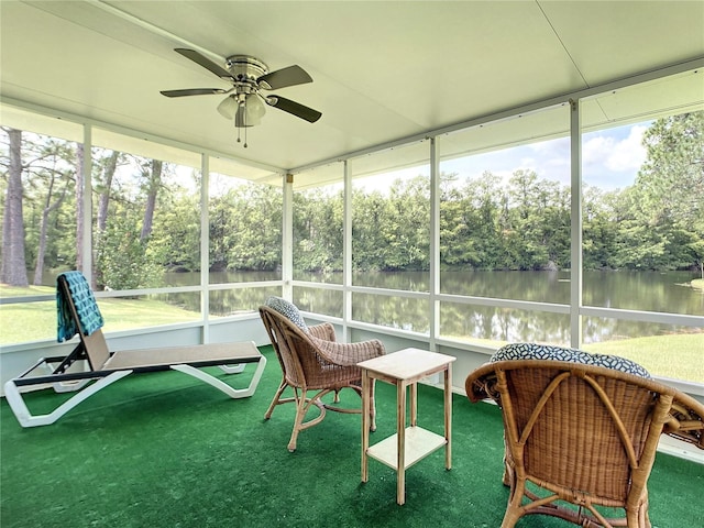 sunroom with a water view, a ceiling fan, and plenty of natural light