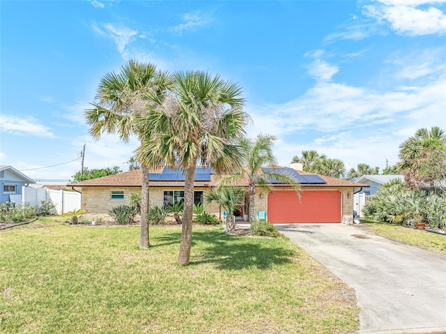 4350 Candlewood Ln, Ponce Inlet, FL 32127 - ranch-style house featuring fence, an attached garage, a front lawn, stone siding, and driveway