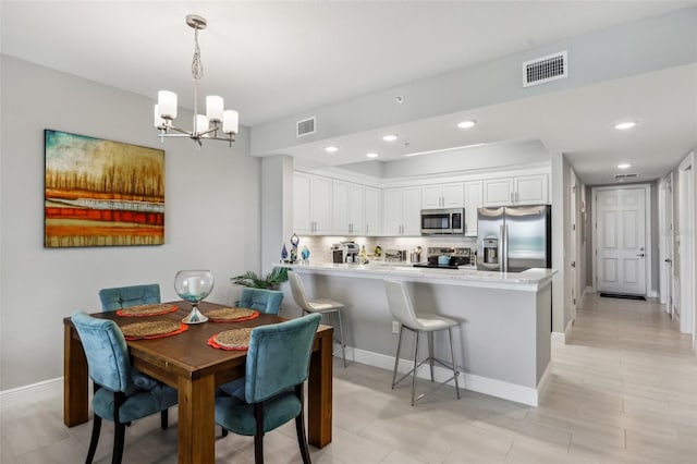 7 Riverwalk Dr Unit 205, New Smyrna Beach, FL 32169 - dining area with a chandelier, baseboards, and recessed lighting