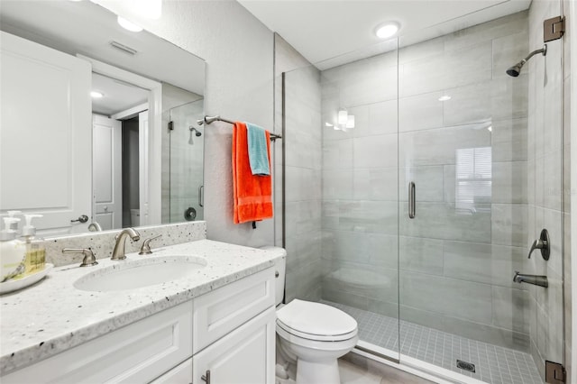 7 Riverwalk Dr Unit 205, New Smyrna Beach, FL 32169 - full bath featuring a shower stall, toilet, vanity, and recessed lighting