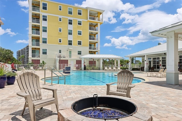 7 Riverwalk Dr Unit 205, New Smyrna Beach, FL 32169 - community pool with an outdoor fire pit, a patio, and fence