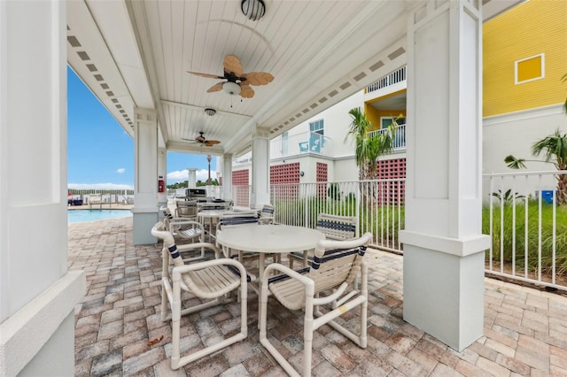 7 Riverwalk Dr Unit 205, New Smyrna Beach, FL 32169 - view of patio with ceiling fan, fence, outdoor dining space, and exterior kitchen