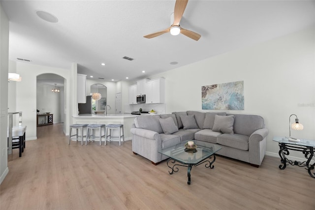 11222 Rapallo Ln, Windermere, FL 34786 - living room with light wood-type flooring, ceiling fan, arched walkways, baseboards, and recessed lighting