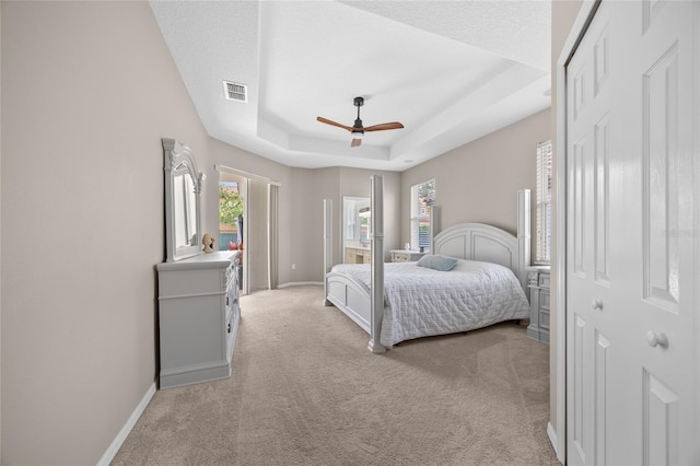 11222 Rapallo Ln, Windermere, FL 34786 - bedroom featuring light carpet, baseboards, a raised ceiling, and a ceiling fan