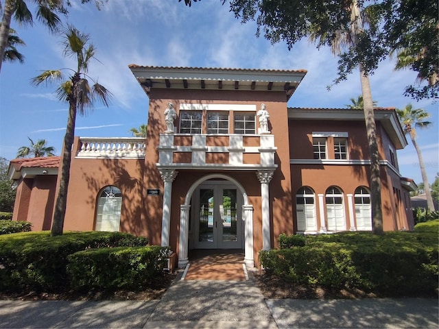 11222 Rapallo Ln, Windermere, FL 34786 - view of front facade featuring french doors, stucco siding, a balcony, and a tile roof