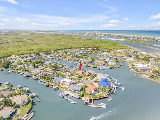 birds eye view of property with a water view and a residential view
