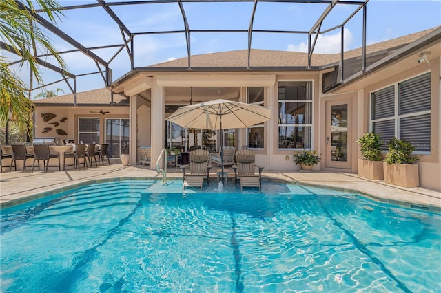 outdoor pool featuring a lanai, a patio, and ceiling fan