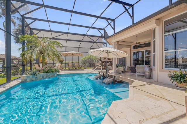 outdoor pool featuring outdoor dining space, a ceiling fan, a patio, and glass enclosure