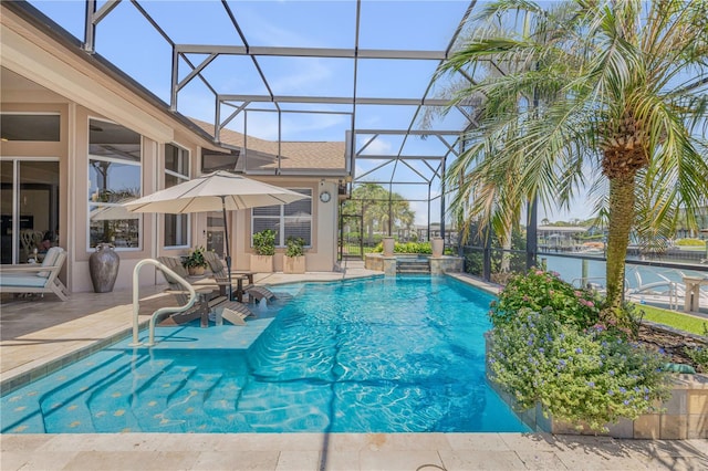 view of pool featuring glass enclosure, a pool with connected hot tub, and a patio area