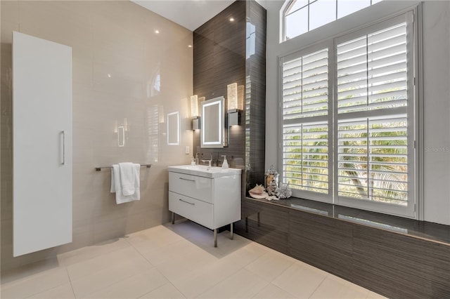 bathroom featuring tile patterned flooring, a high ceiling, and vanity