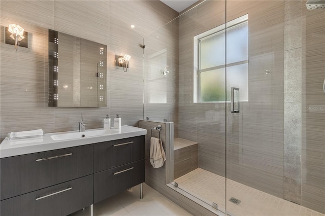 bathroom with vanity, tile walls, tile patterned floors, a shower stall, and backsplash