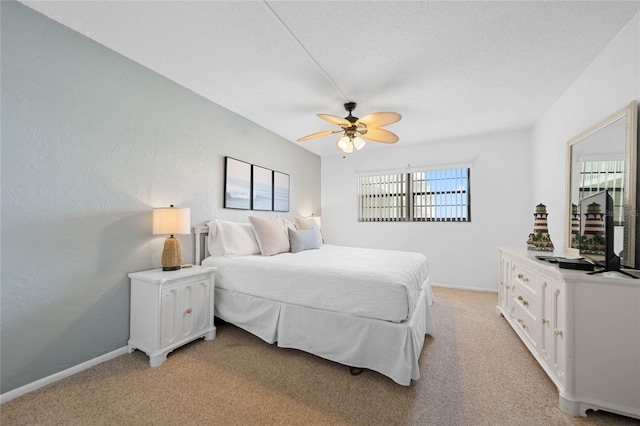 bedroom with baseboards, ceiling fan, and light colored carpet