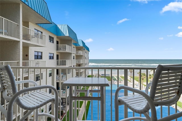balcony with a beach view and a water view