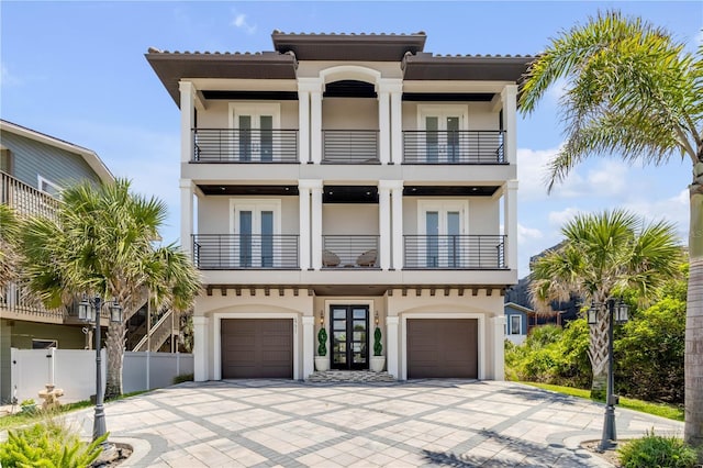 6771 Turtlemound Rd, New Smyrna Beach, FL 32169 - view of front of home with stucco siding, french doors, and a balcony